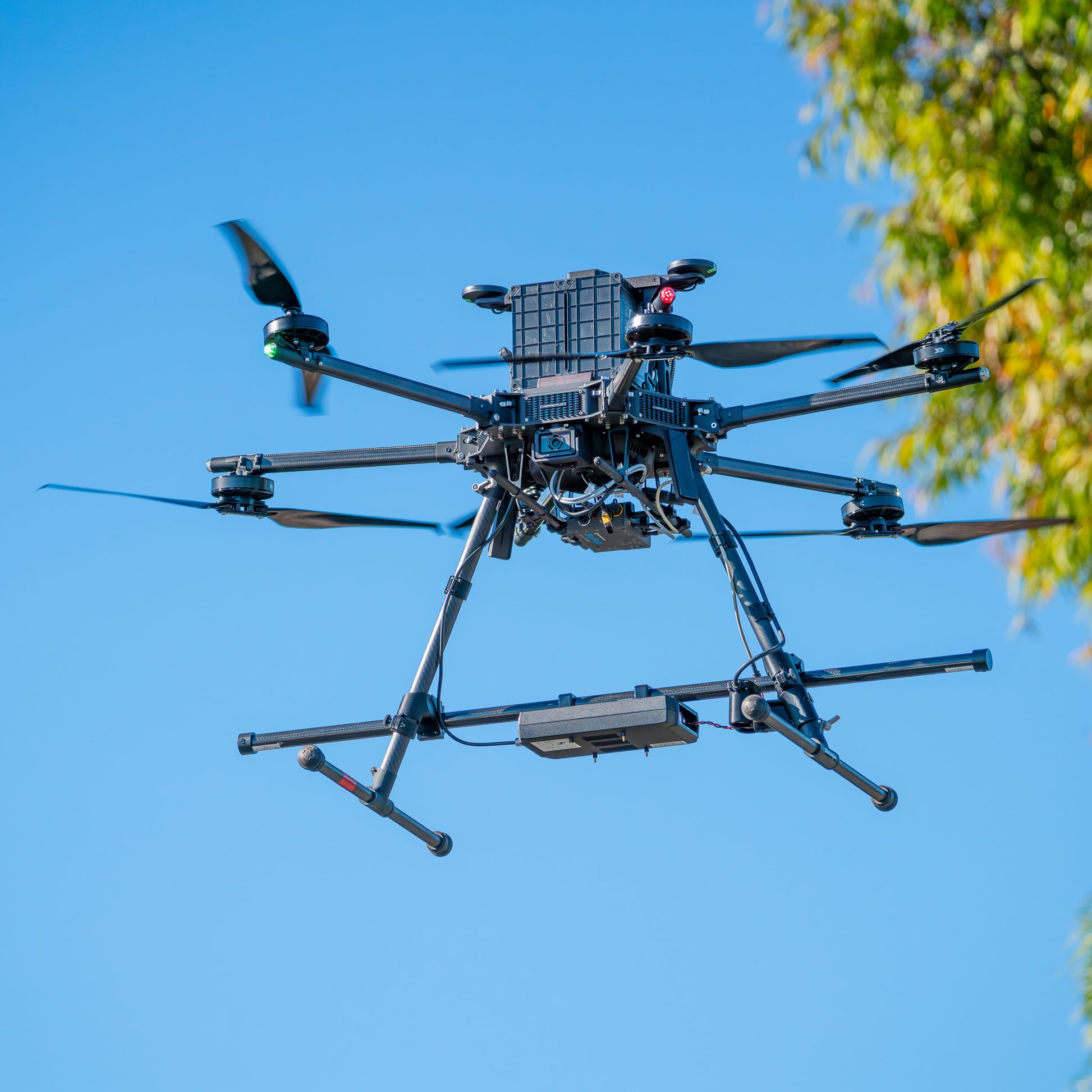 IF1200 drone equipped with SENSYS MagDrone R4 magnetometer payload conducting aerial magnetic survey